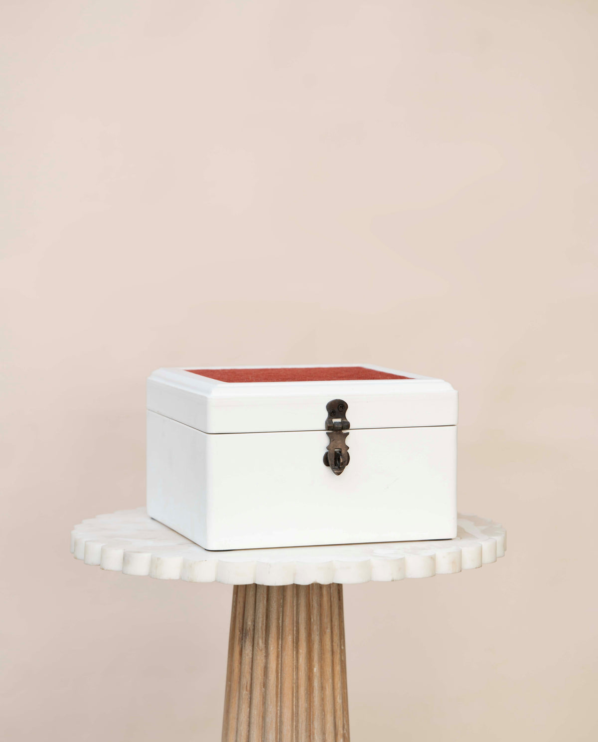White wooden jewelry box or decorative box with a red fabric on top