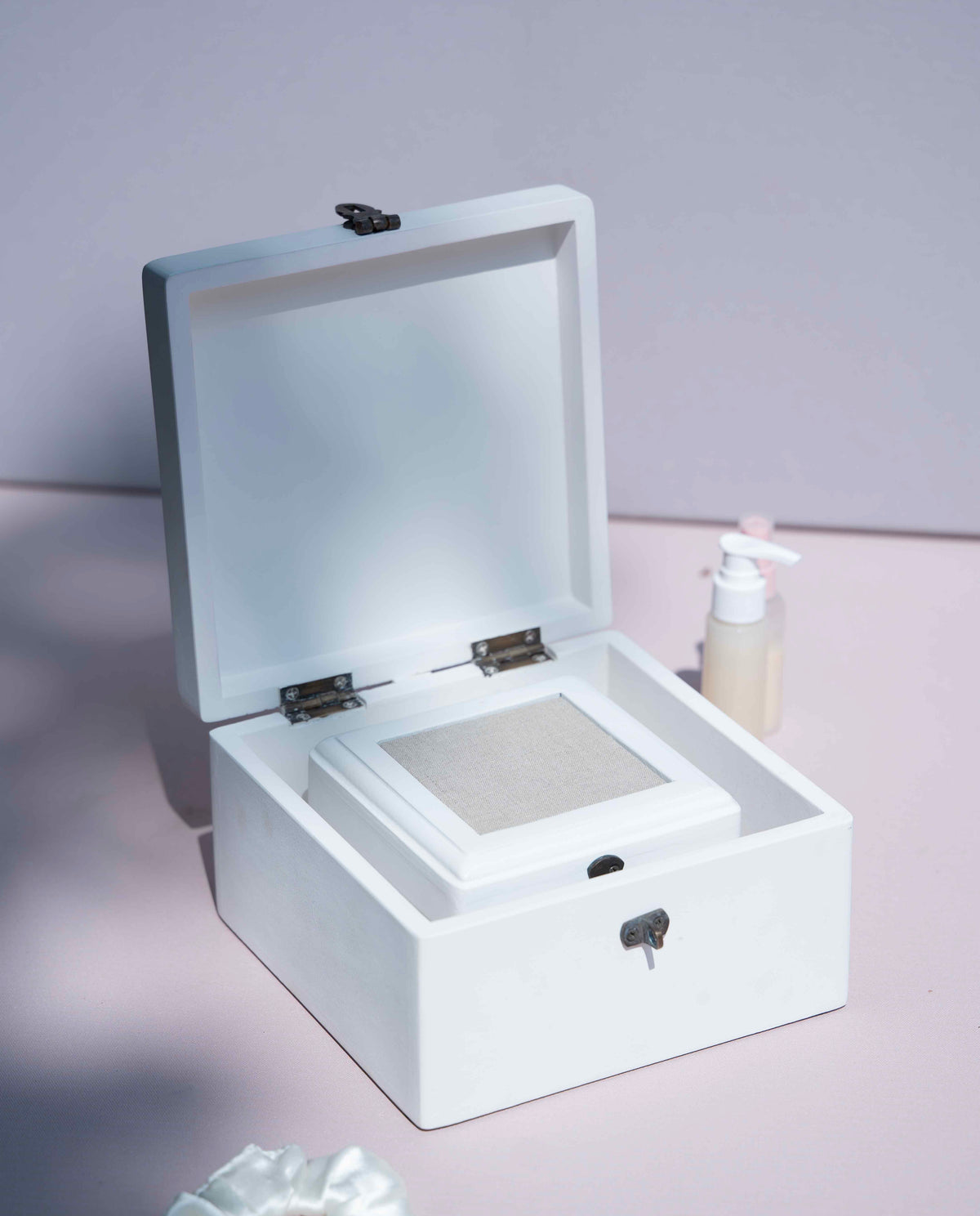A white cosmetic storage box or decorative box with an open lid