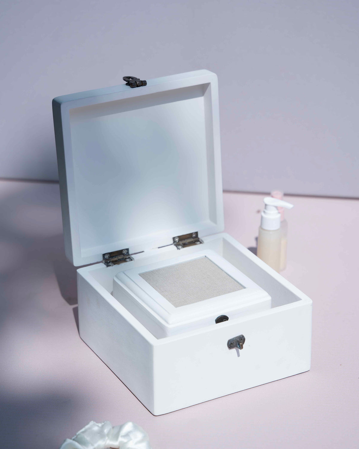 A white cosmetic storage box or decorative box with an open lid