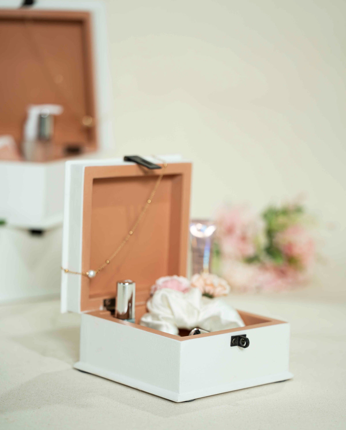A white wooden jewelry keepsake box with a hinged lid