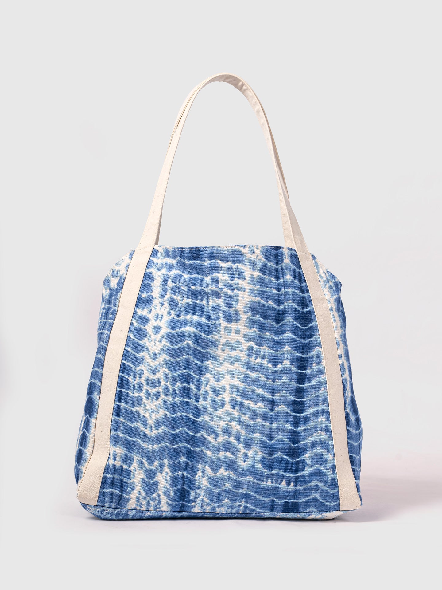 Blue tie-dye tote bag with white straps