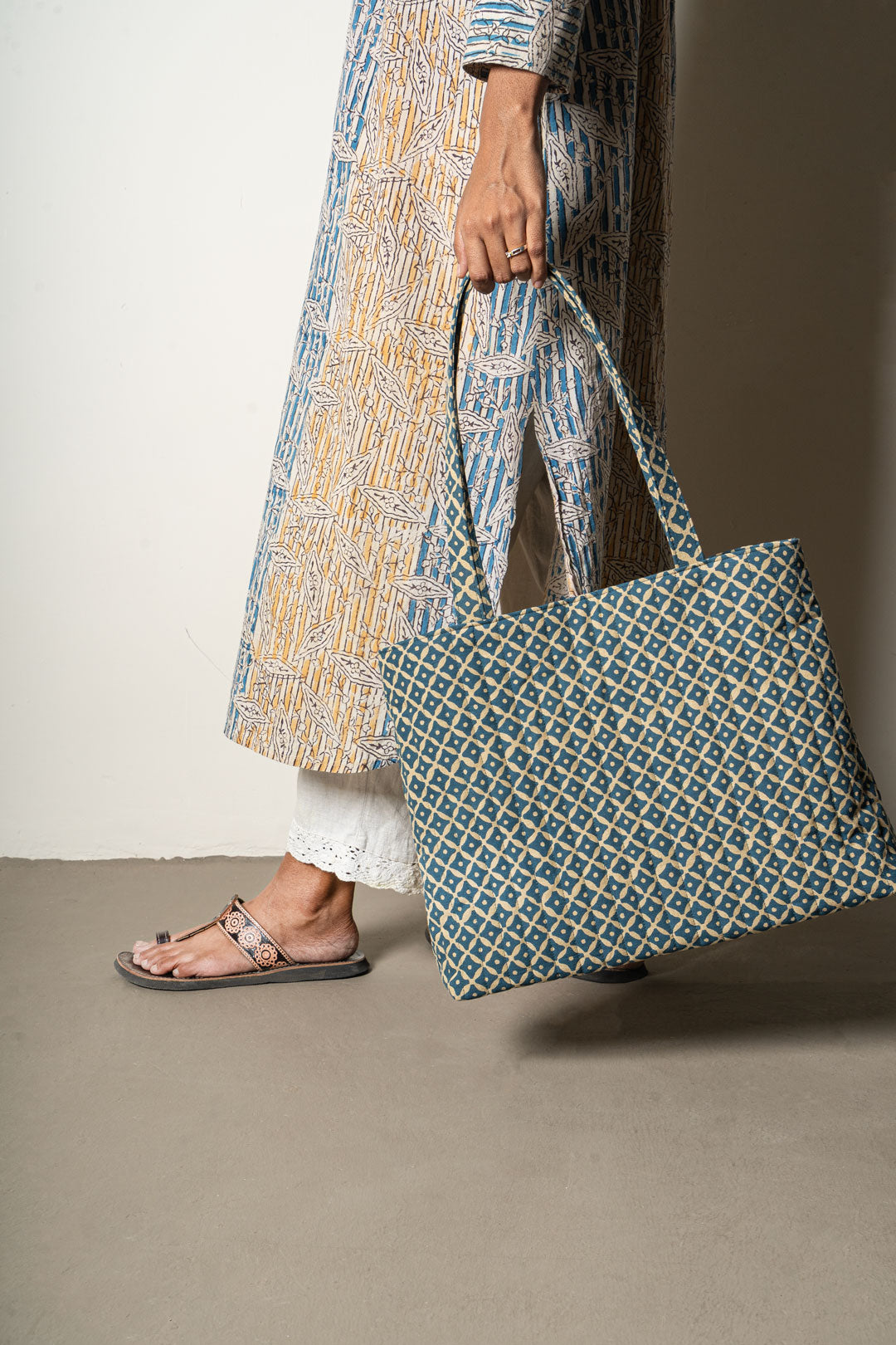 Person holding a patterned tote bag 