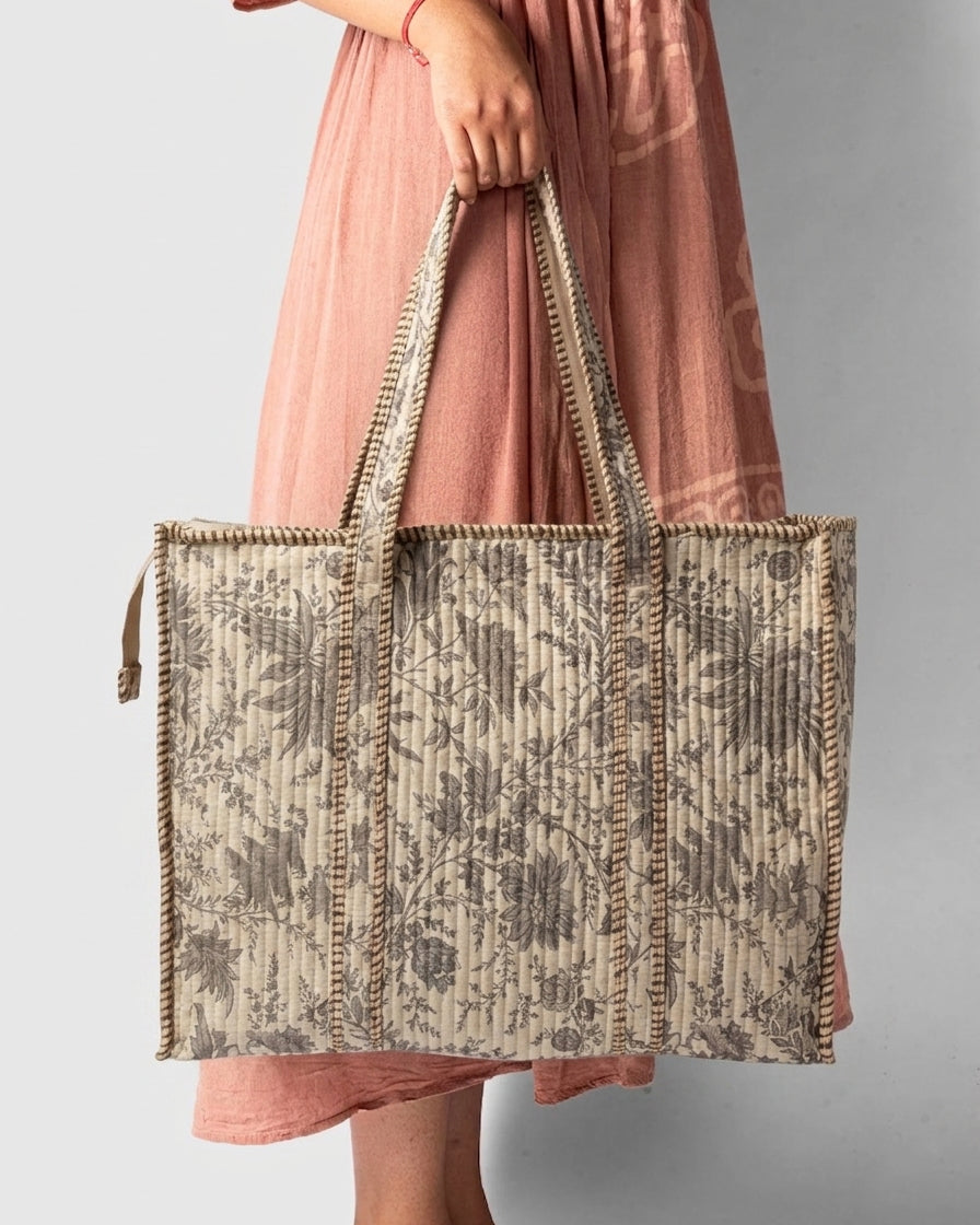 Person holding a patterned tote bag 