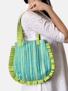 Green and blue striped handbag with ruffled edges