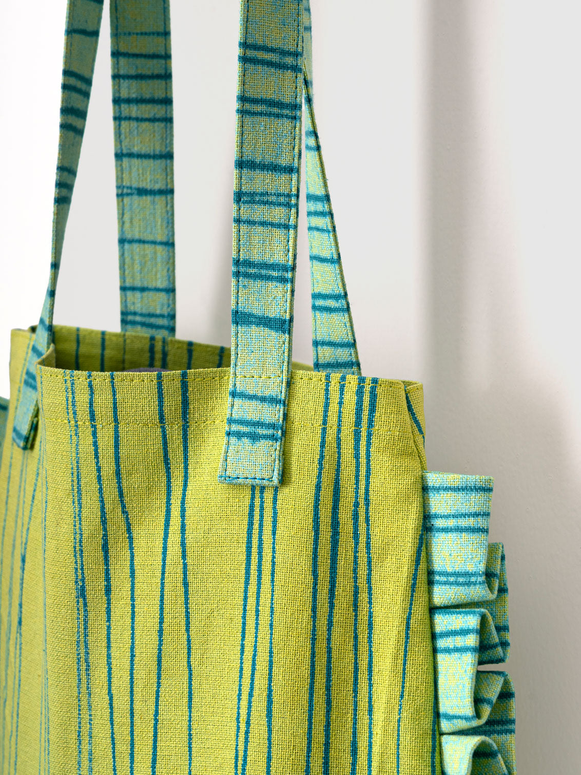 Green and blue striped mini tote bag with ruffled edges