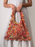 Person with a floral-patterned velvet floral tote bag