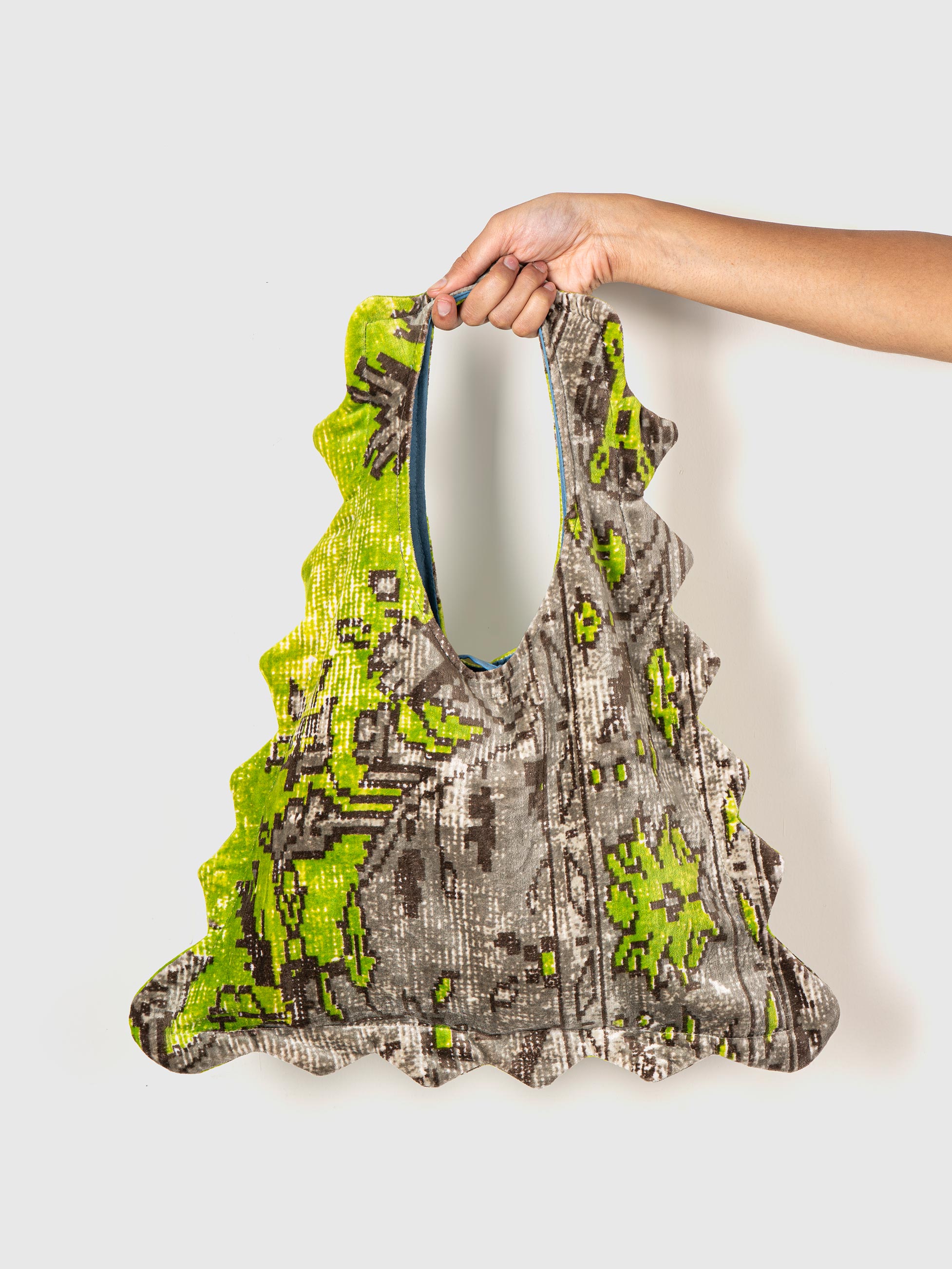 a printed tote bag with green and gray design